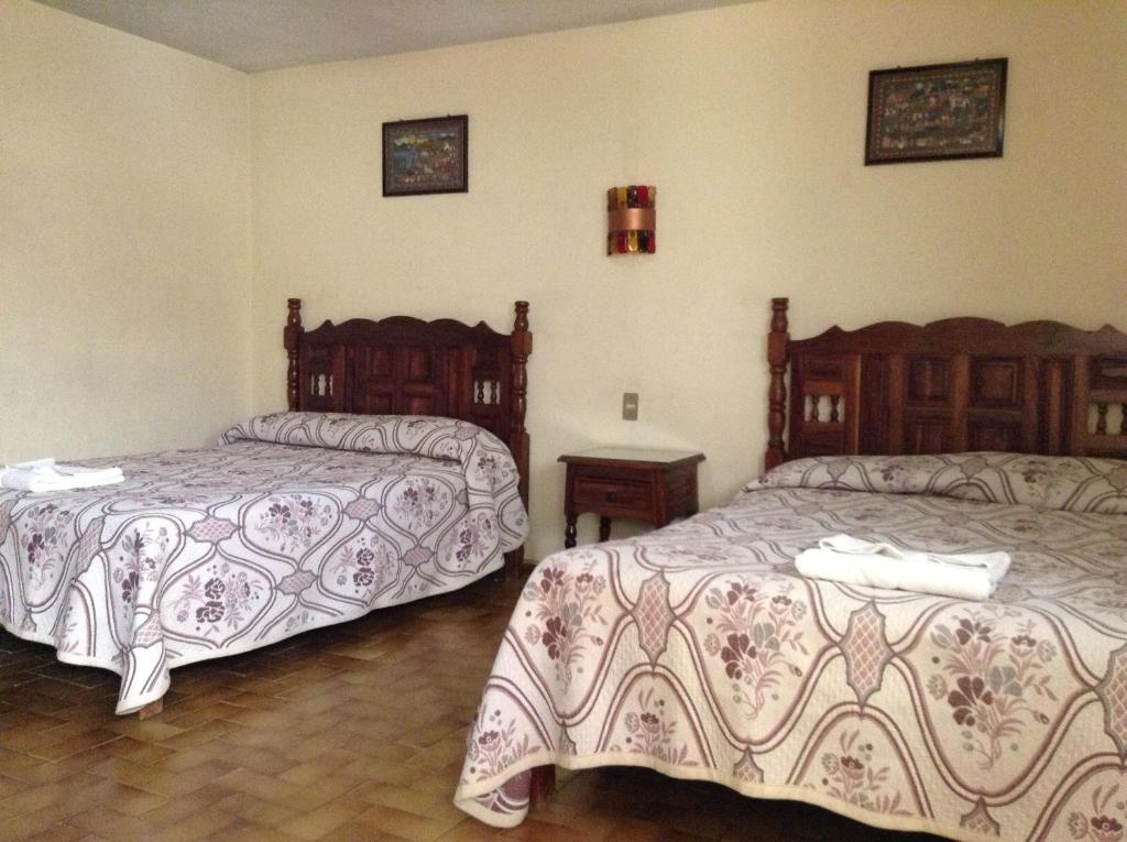 Postel nebo postele na pokoji v ubytování Hotel Atilanos