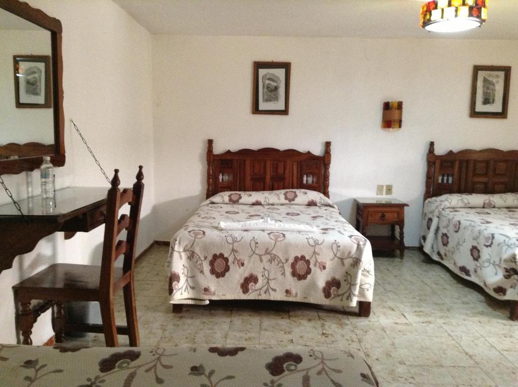 Postel nebo postele na pokoji v ubytování Hotel Atilanos