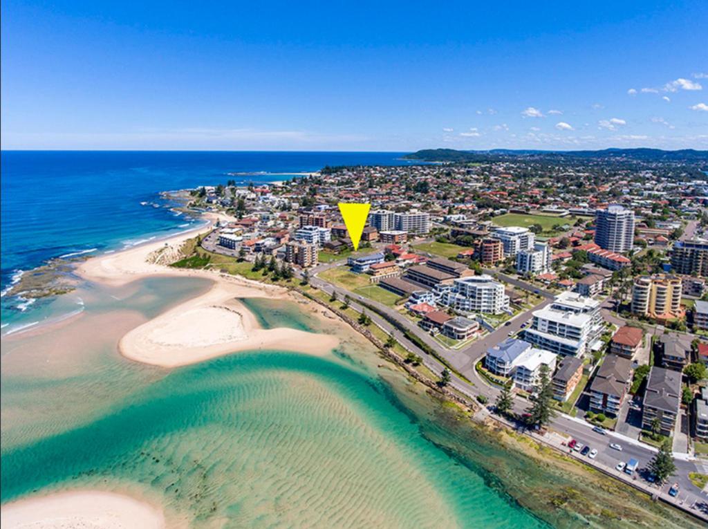 an aerial view of a beach with a yellow arrow at The Fisherman's Shack in The Entrance