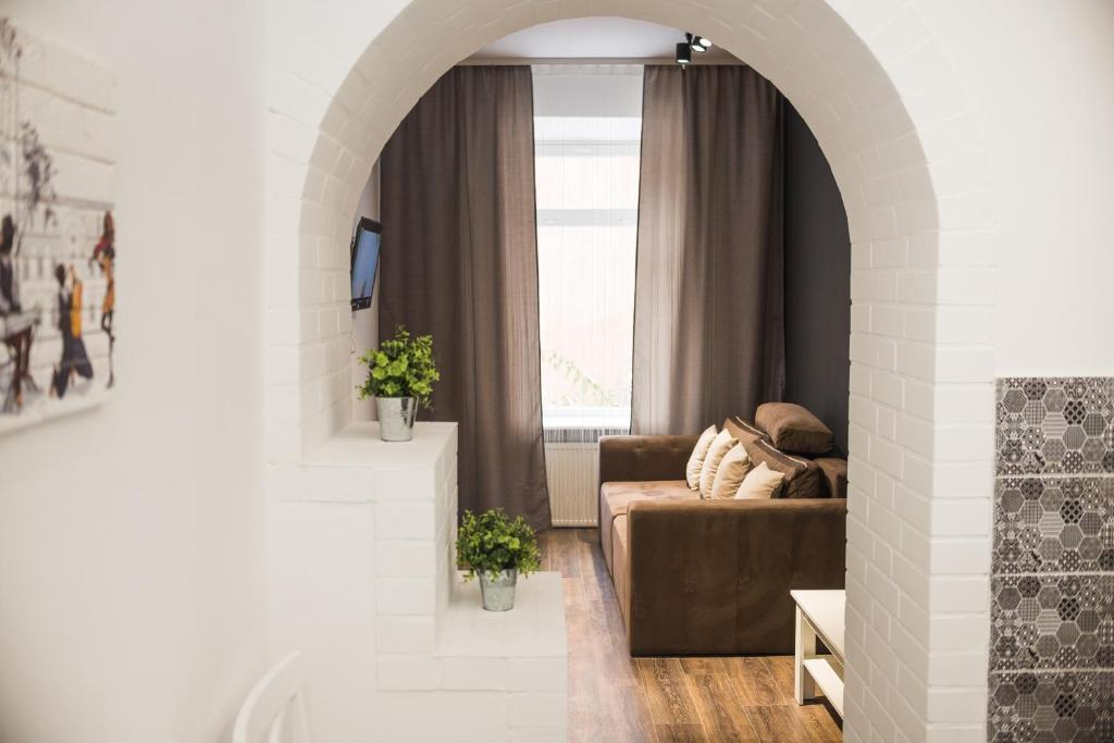 a living room with a couch and a window at Modern apartment in Lviv