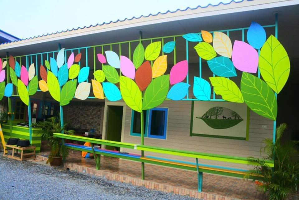 a building with a colorful mural on the side of it at Boon Nam Fah Resort in Chao Lao Beach