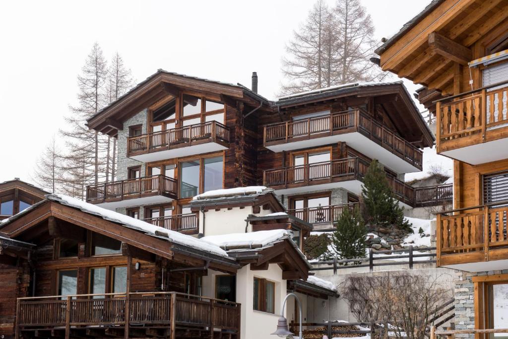 a ski lodge with snow on the roof at Haus Leytron in Zermatt