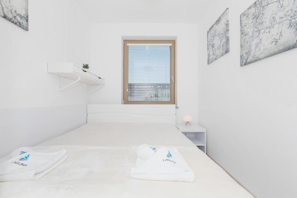 Postel nebo postele na pokoji v ubytování Wind Rose Quarter Apartments by Noclegi Renters