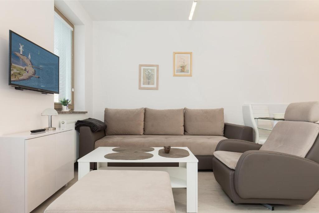Posezení v ubytování Wind Rose Quarter Apartments by Noclegi Renters