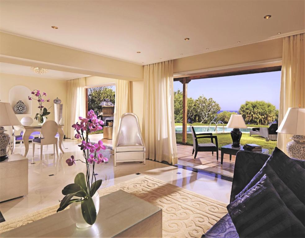 a living room with a couch and a table at Out Of The Blue Resort & Spa in Agia Pelagia