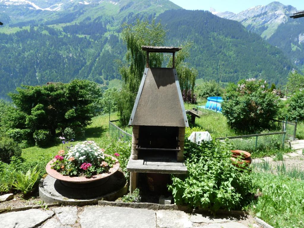 a garden with a bird feeder and some flowers at Chalet Gerbera in Wengen