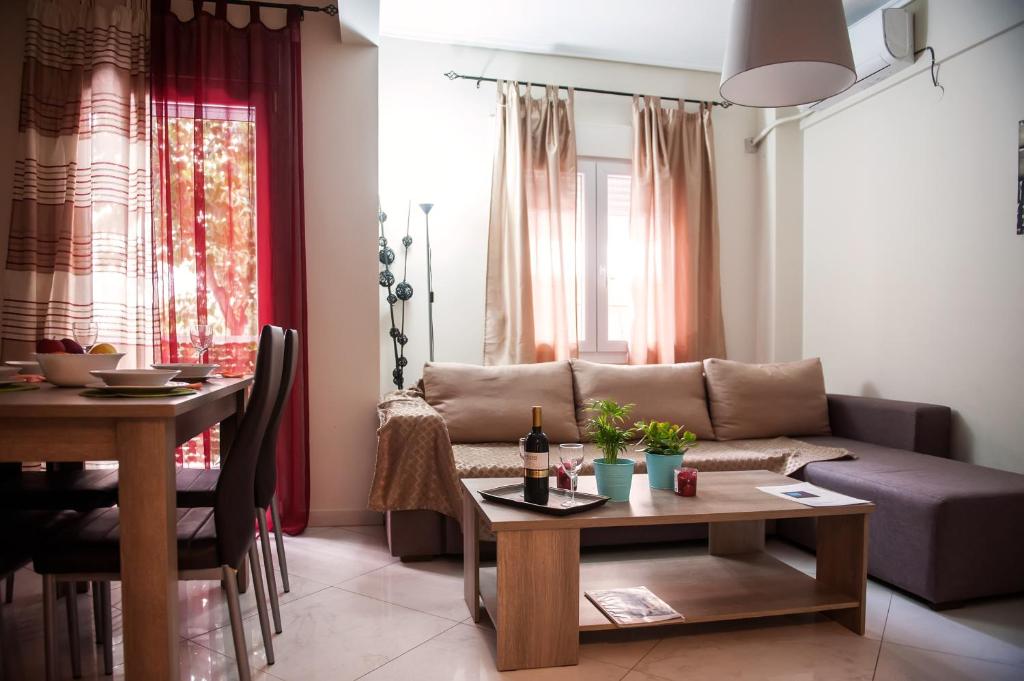a living room with a couch and a table at City House Apartment in Thessaloniki