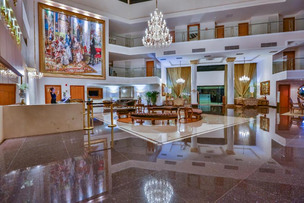 a lobby of a hotel with a chandelier at Golden Lis Hotel Boutique in Goiânia