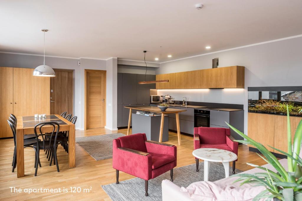 a kitchen and living room with a table and chairs at Maironis apartment 2 in Kaunas