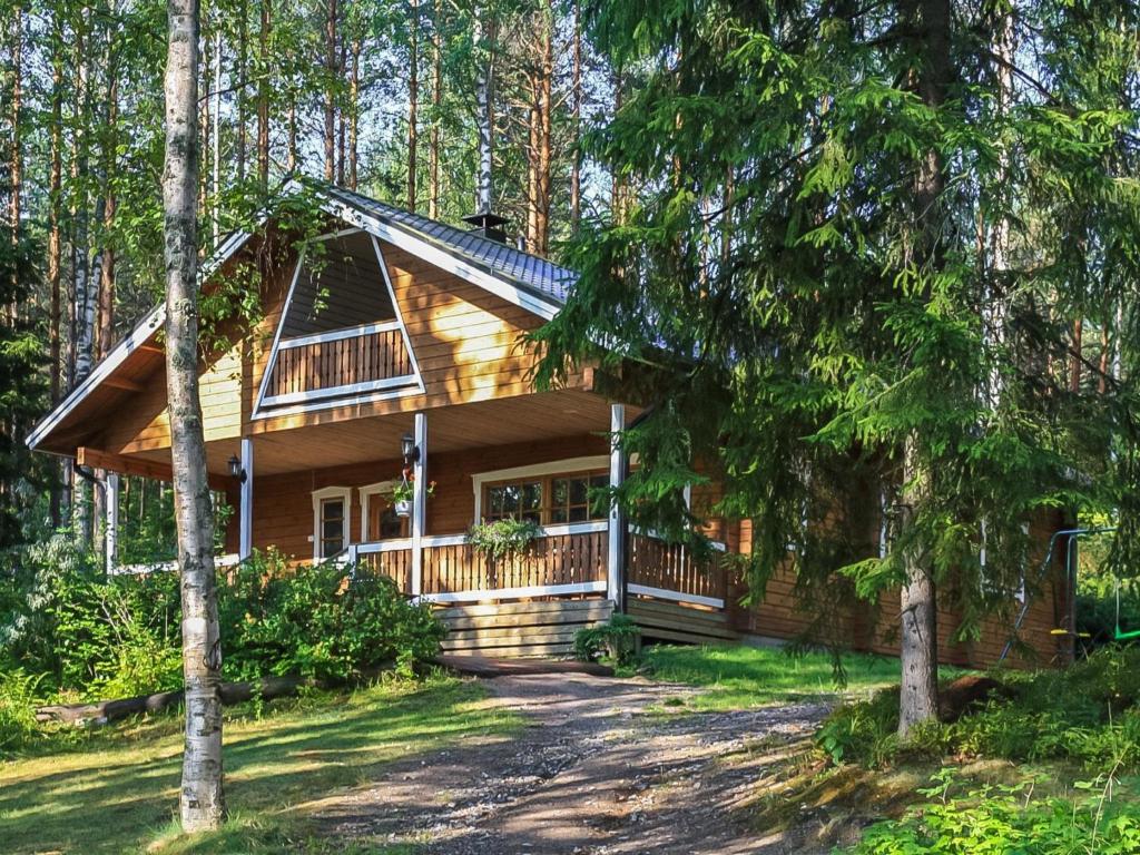 a log cabin in the woods with a driveway at Holiday Home Salmensuu by Interhome in Havumäki