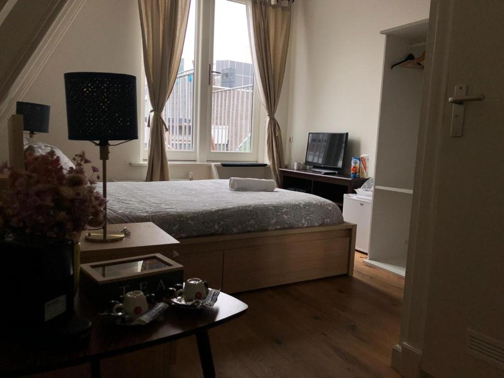 a bedroom with a bed and a large window at A'DAM ROOFTOP LUX in Amsterdam