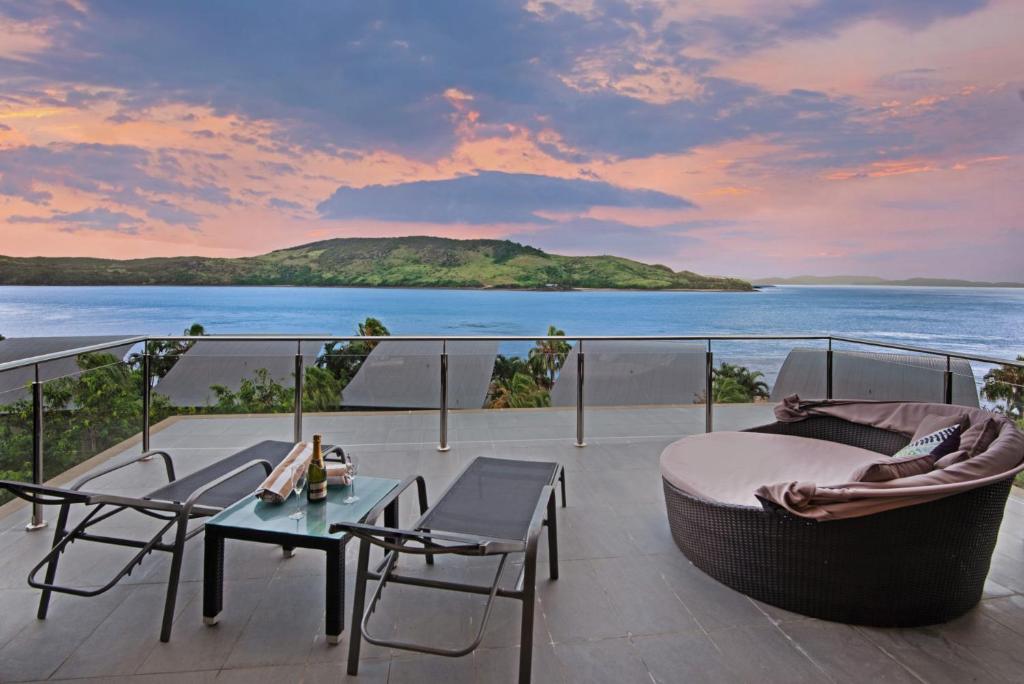 a balcony with a view of the ocean at Yacht Club Villa 33 - Serenity - 4 Bedroom 4 Bathroom House Ocean Views 2 Buggies in Hamilton Island