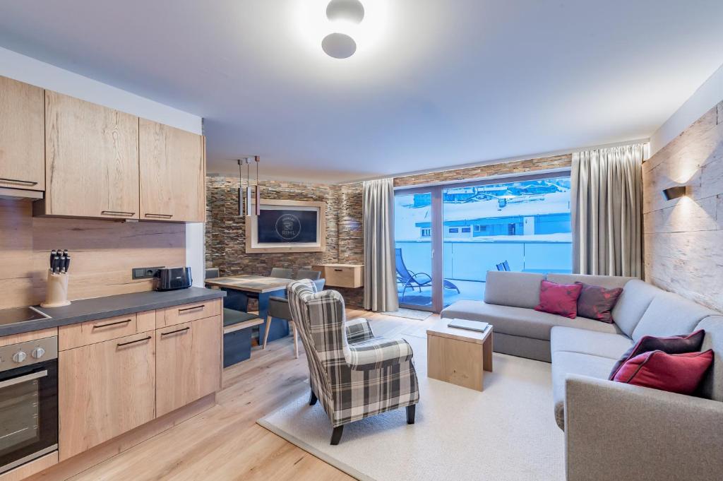 a kitchen and living room with a couch and a table at Piccard Nº 5 in Obergurgl
