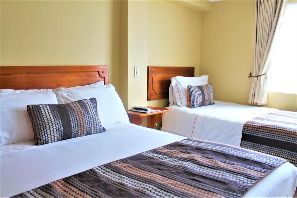 Postel nebo postele na pokoji v ubytování Hotel Estación Sabana