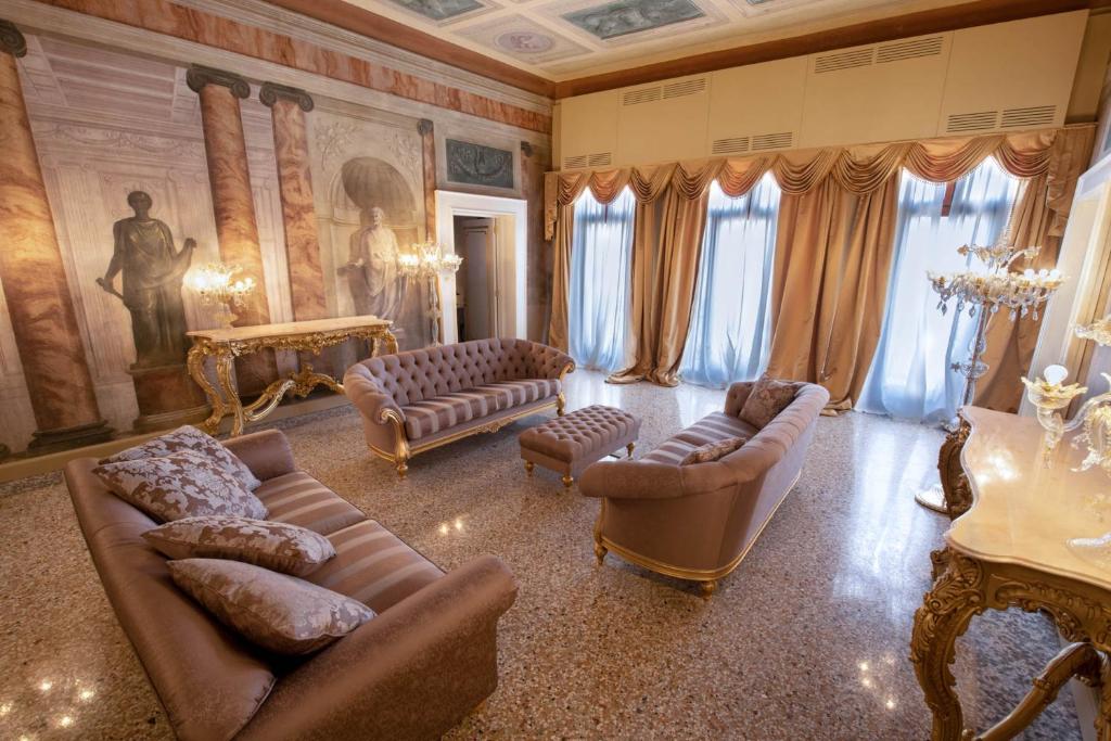 a living room with couches and chairs and a painting at Ca' Bonfadini Historic Experience in Venice