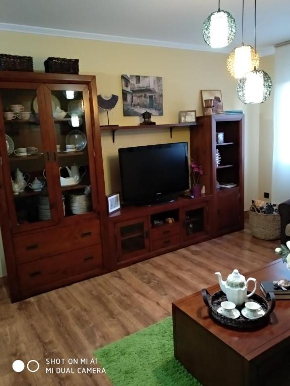 a living room with a entertainment center and a television at Calle Maliayo in Villaviciosa
