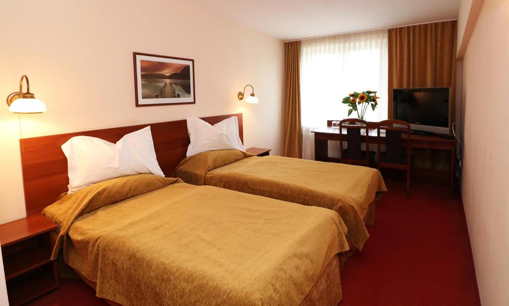 מיטה או מיטות בחדר ב-Hotel Adria