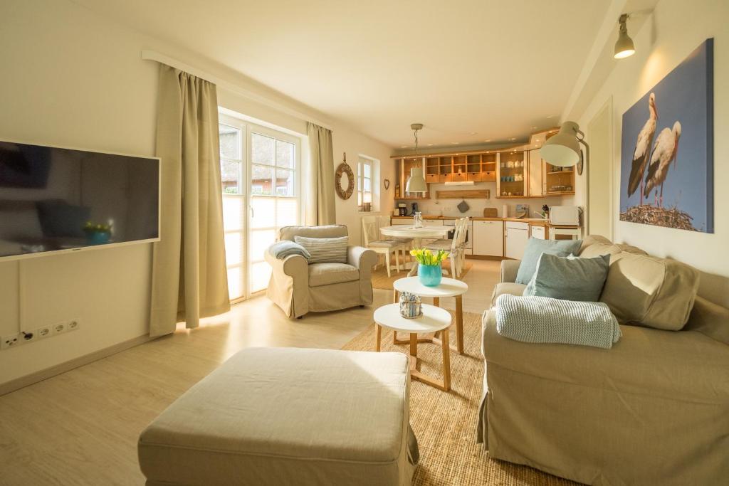 a living room with a couch and a table at Hus op de Dun in Sankt Peter-Ording