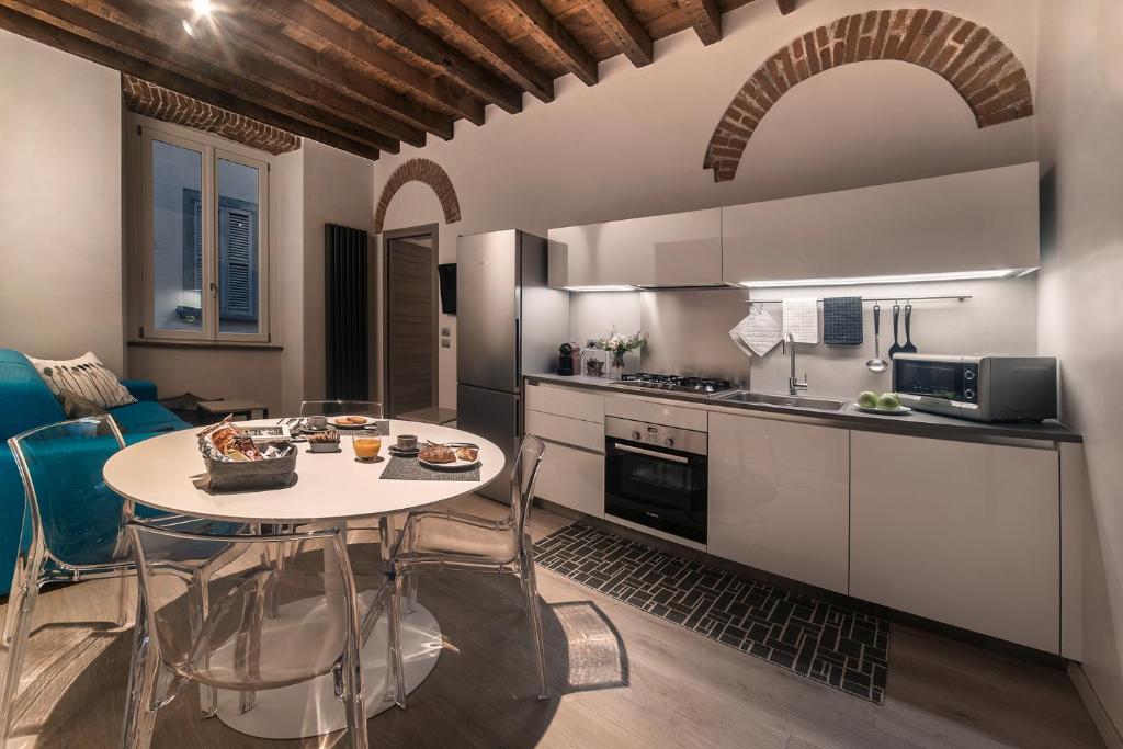 a kitchen with a table and chairs in a room at Borgo San Leonardo in Bergamo