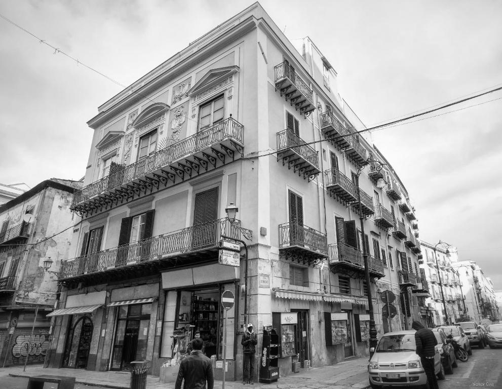 a black and white photo of a building on a street at Maison Cutò in Palermo