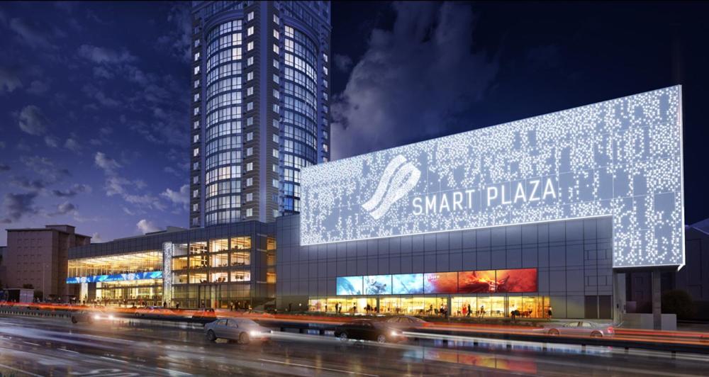 a large building with a sign on the side of it at Apart Assistant on Smart Plaza in Kyiv