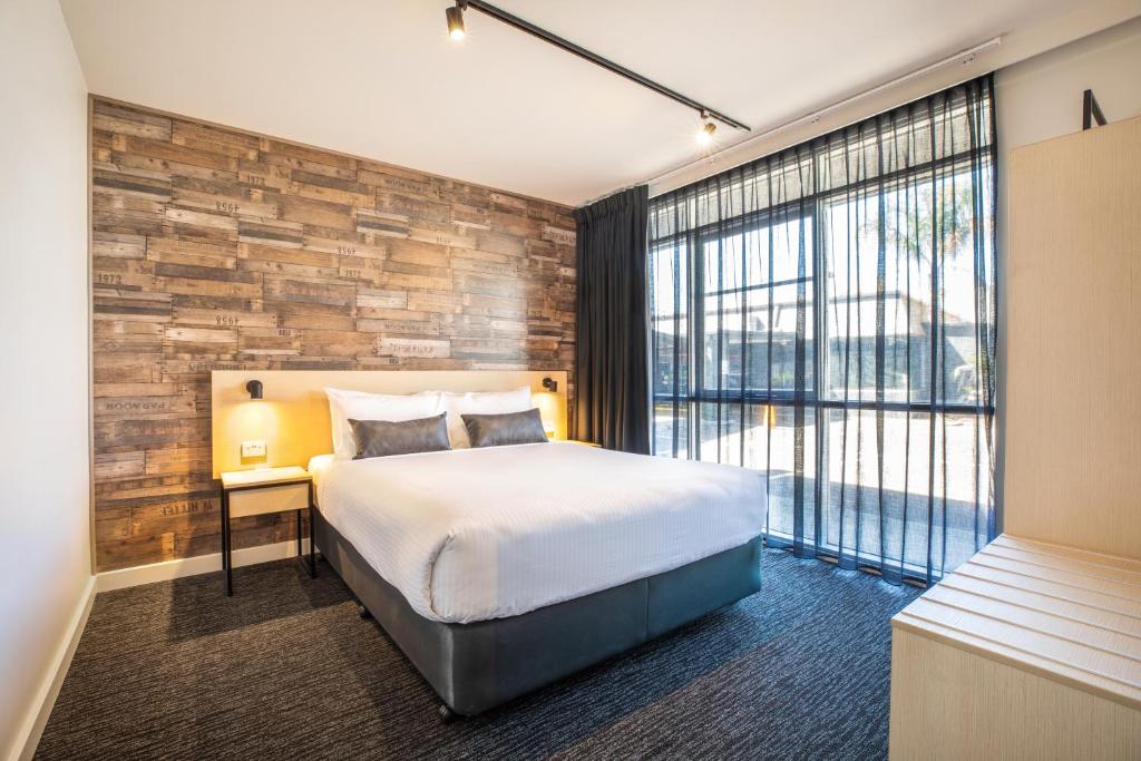 a hotel room with a bed and a large window at Nightcap at Westside Hotel in Laverton