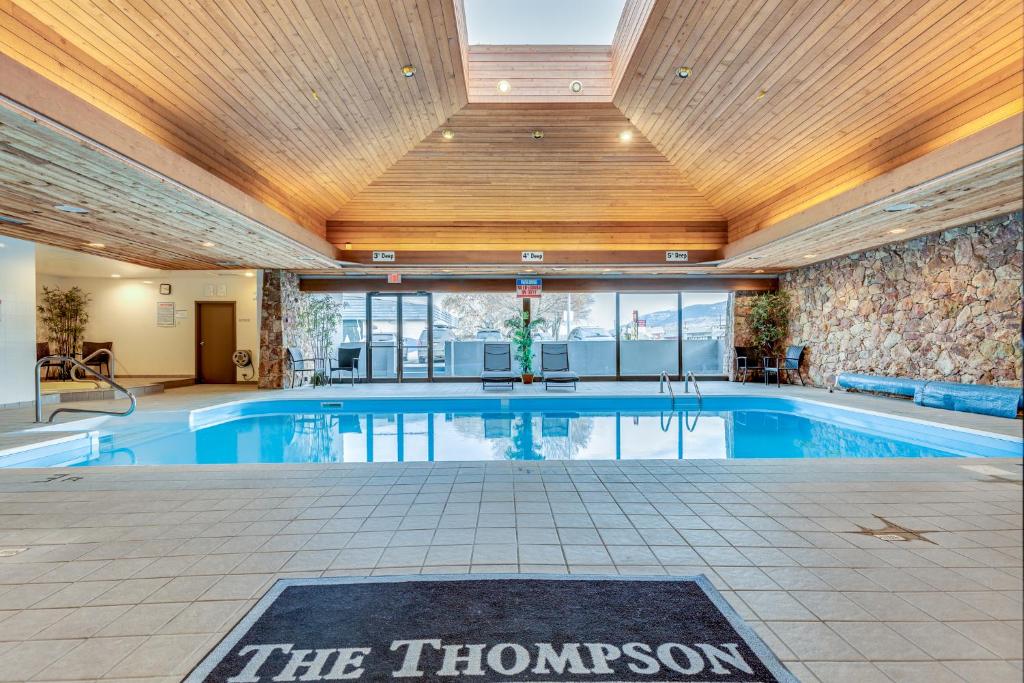 a swimming pool in a building with a ceiling at The Thompson Hotel in Kamloops