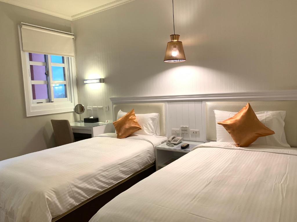 Postel nebo postele na pokoji v ubytování Joy Hotel