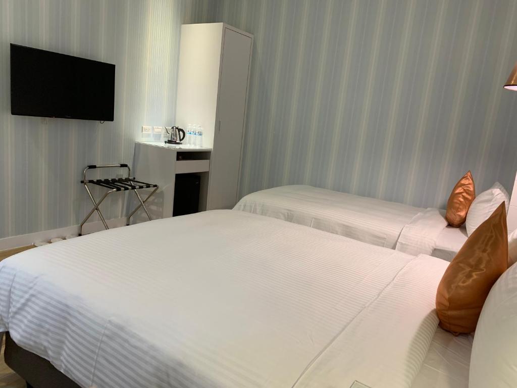 Postel nebo postele na pokoji v ubytování Joy Hotel