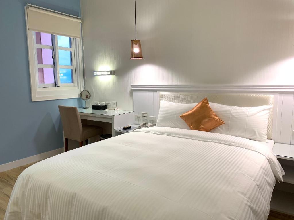 Postel nebo postele na pokoji v ubytování Joy Hotel