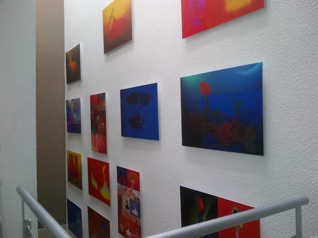 a wall with colorful pictures on a wall at Hotel Molinos in Granada