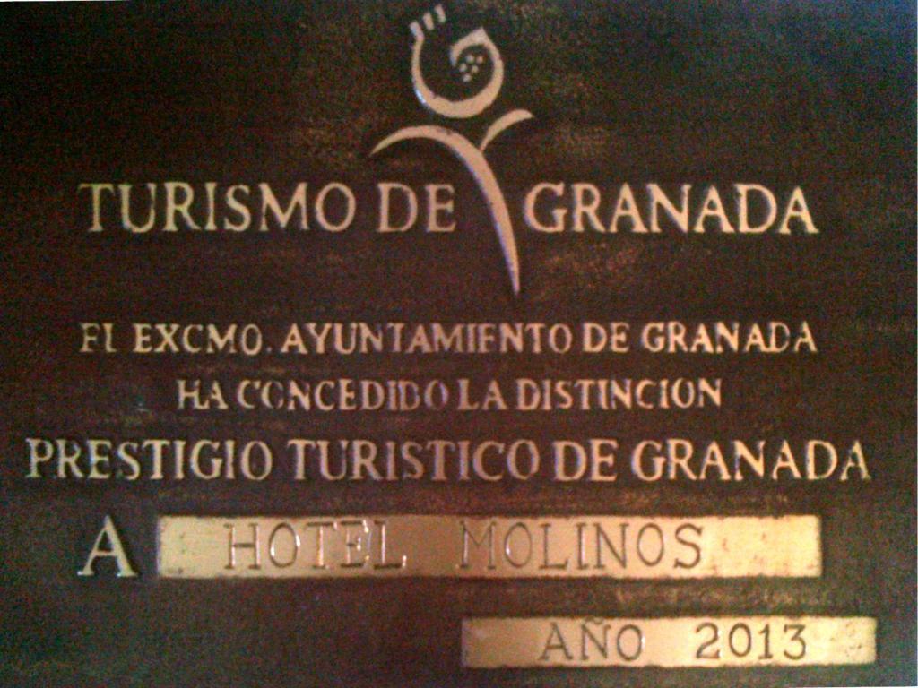 a sign for a hotel in a foreign language at Hotel Molinos in Granada