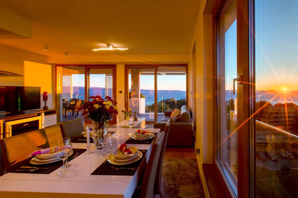 Bel Etage Amora Luxury Seaview Apartment with pool في سبليت: غرفة معيشة مع طاولة طعام مطلة
