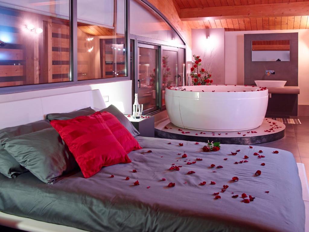 a bedroom with a large bed and a bath tub at Le Dimore Di Ponte Selce in Fondi