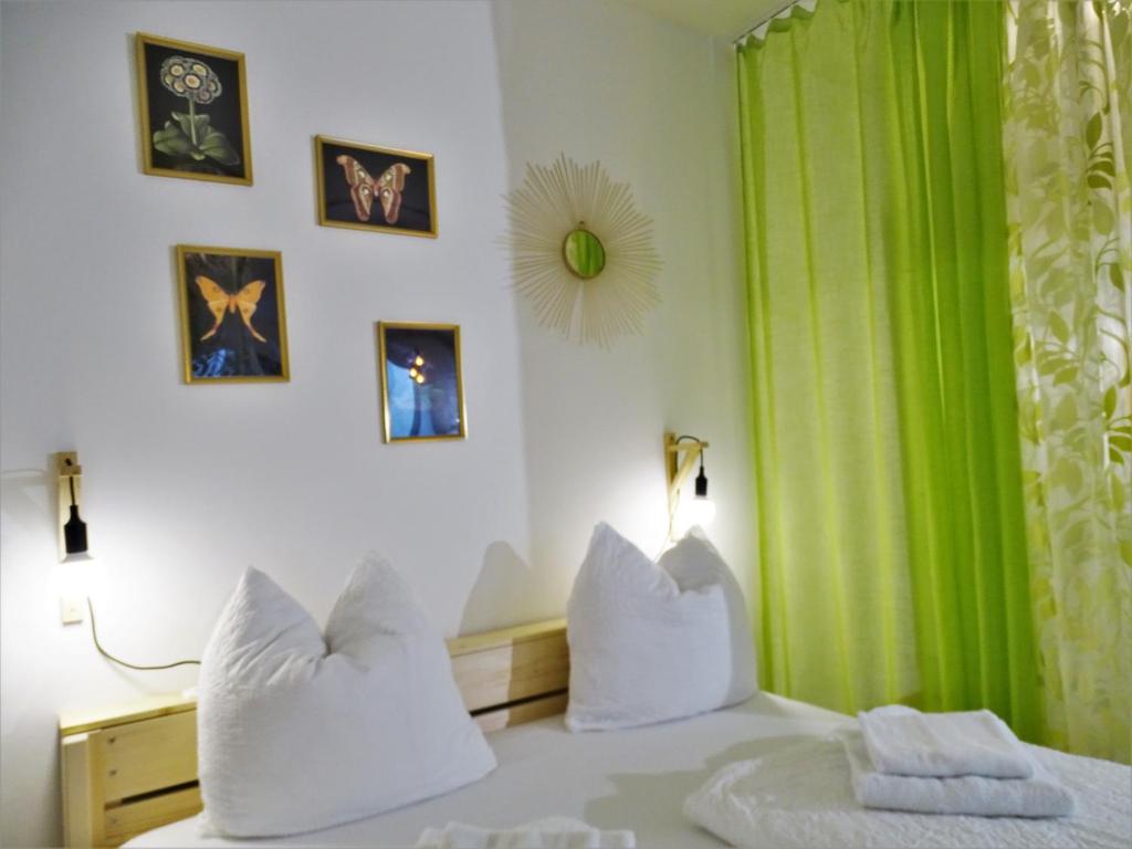 a bedroom with a bed with a green curtain at City by BestChoice - FREE Parking - Self Check-in in Graz