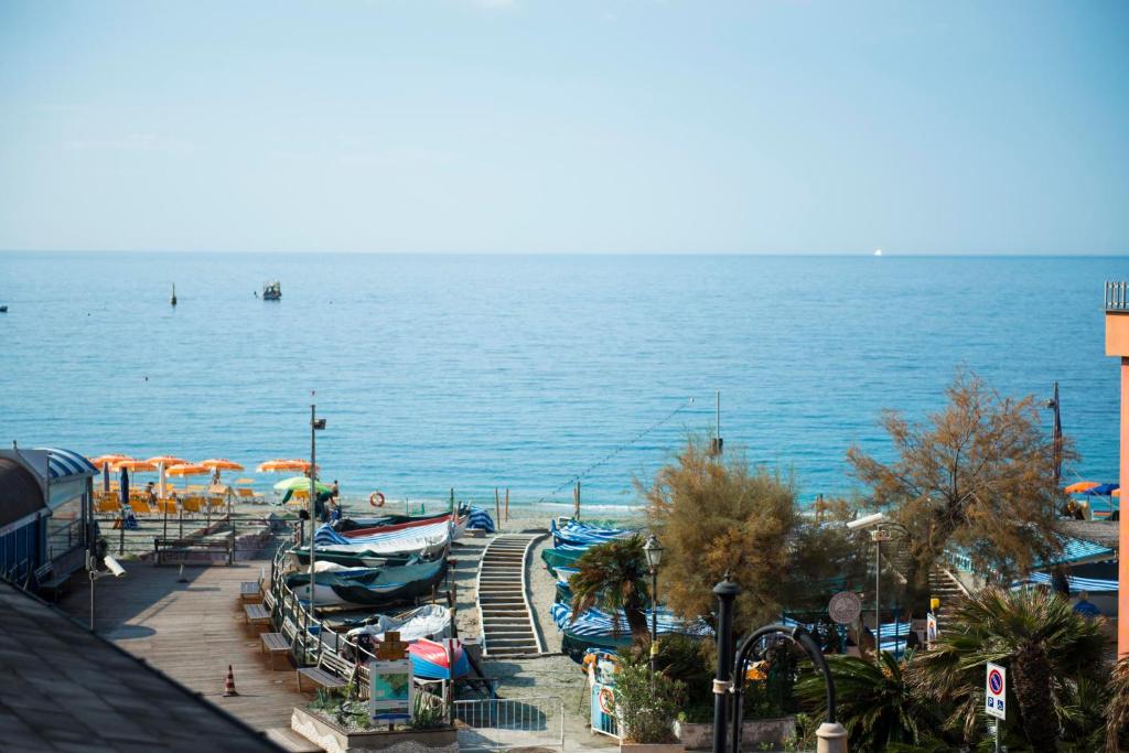 a view of a beach with boats and umbrellas at Casa Maestrale -Mistral Sea Breeze in Monterosso al Mare