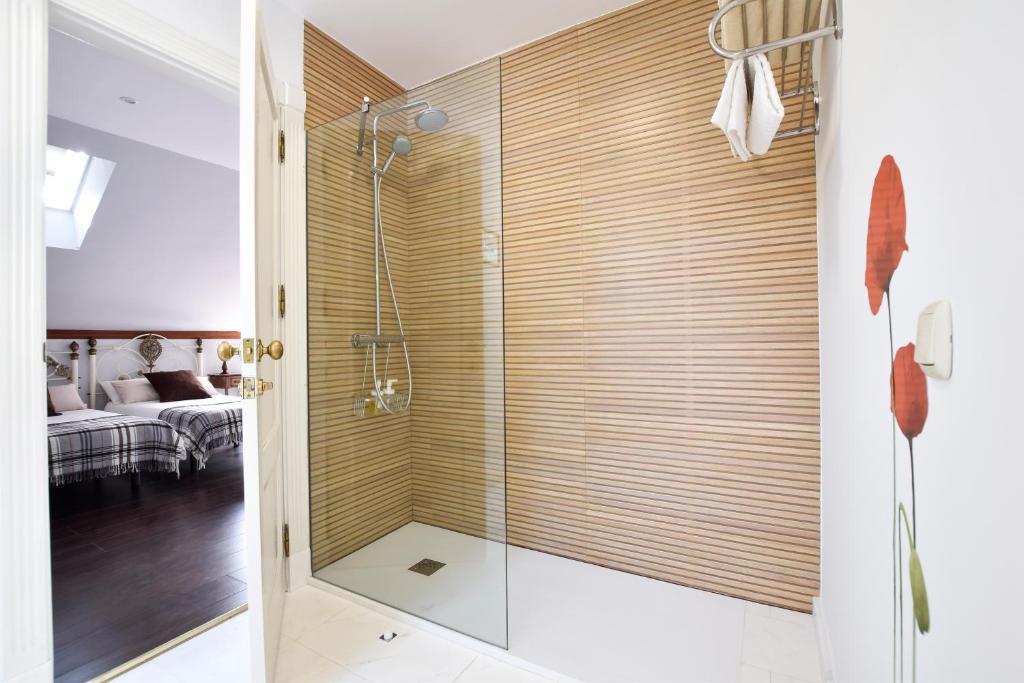 a shower with a glass door in a bathroom at Villa Antumalal B&B in Málaga
