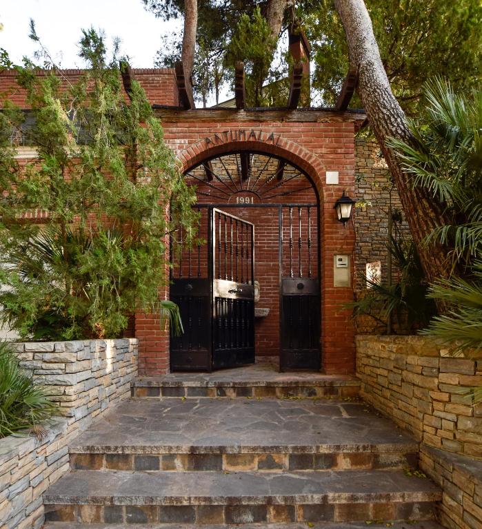 an entrance to a brick building with a gate at Villa Antumalal B&B in Málaga