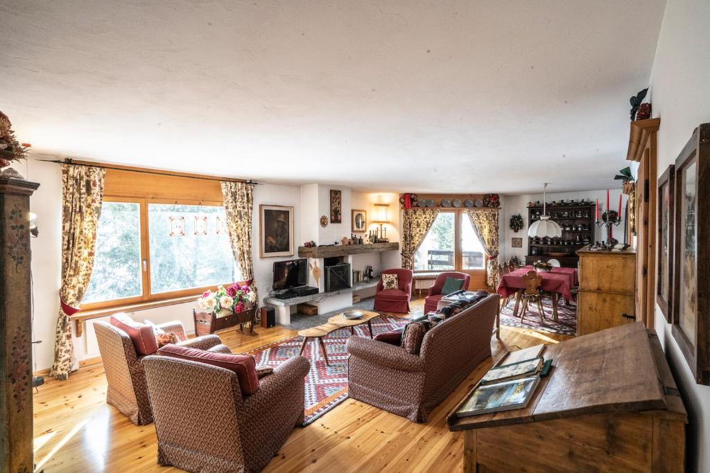 a living room with chairs and a table at Chesa Pradash - Celerina in Celerina