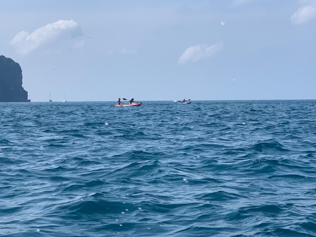 a group of people in a boat in the ocean at Phi Phi Green Hill Resort in Phi Phi Don