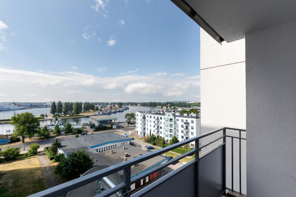 a view of a city from a balcony of a building at Premium apartment with a port view by Renters in Świnoujście