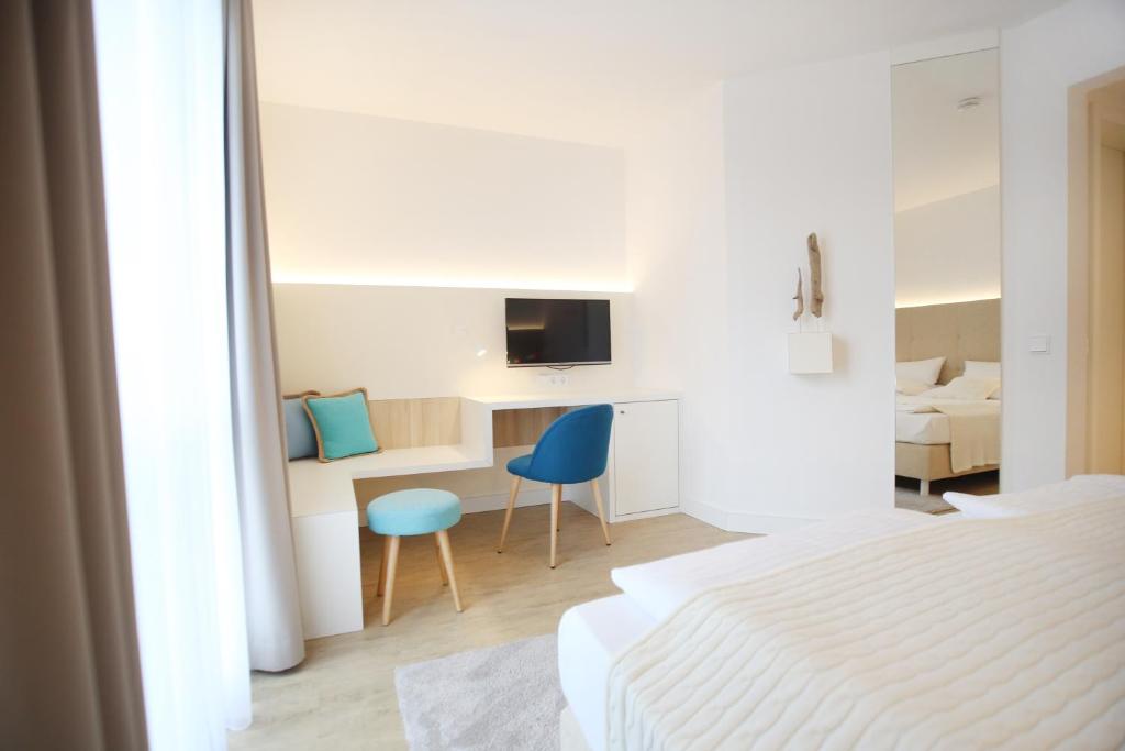 Postel nebo postele na pokoji v ubytování Boutique Hotel Reschen