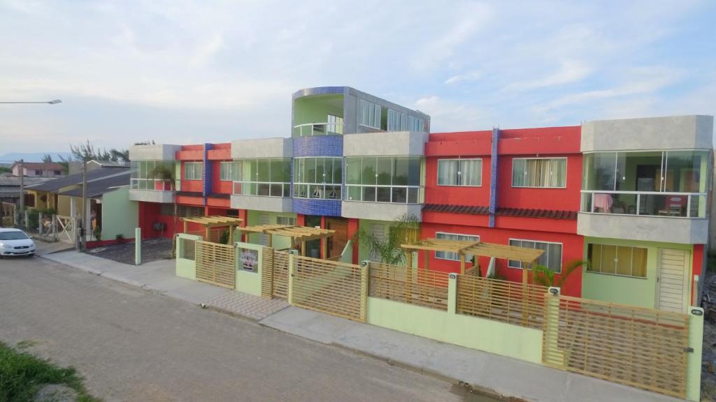 a building with colorful paint on the side of a street at Residencial Veleiros Do Mar in Capão da Canoa