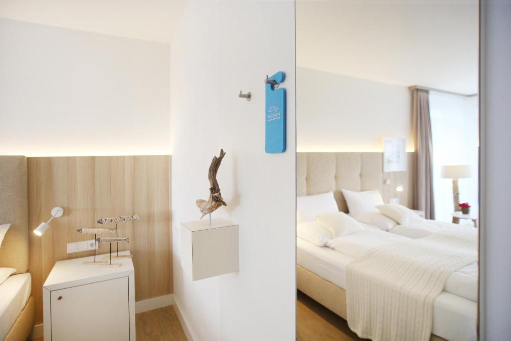 Postel nebo postele na pokoji v ubytování Boutique Hotel Reschen