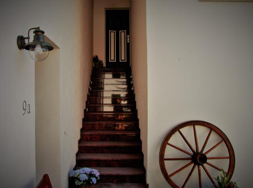 a staircase in a house with a door and a wheel at Alter Fritz Erfurt in Erfurt