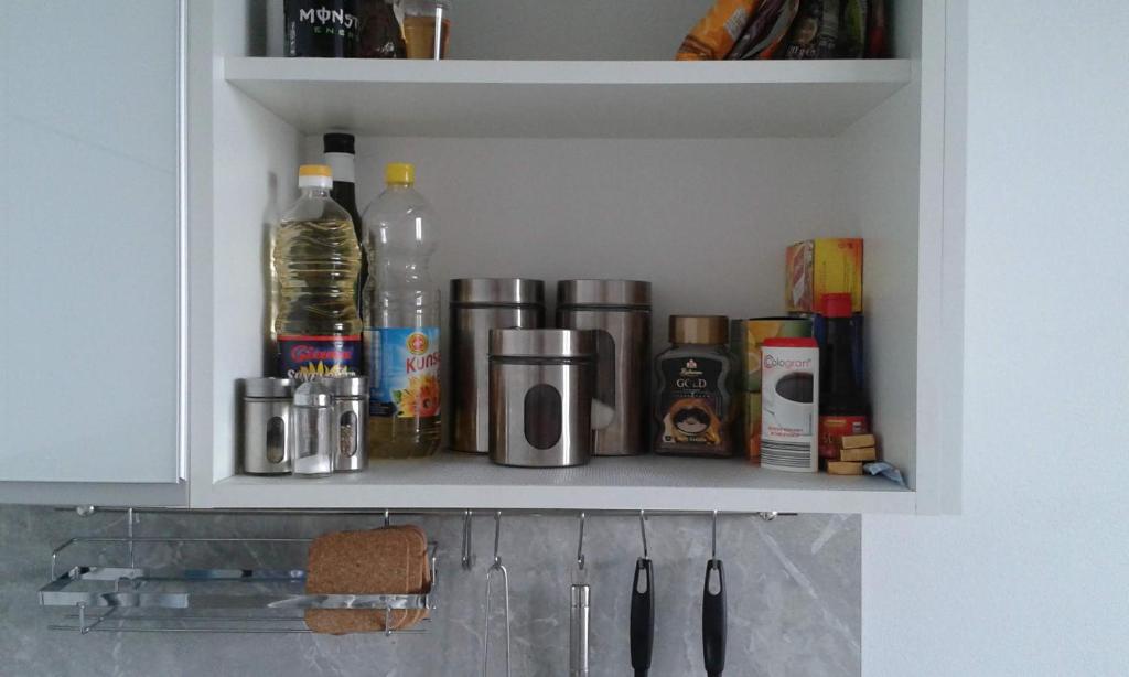 a kitchen cabinet with bottles and other items on it at Mountain View Studio Apartment in Poprad