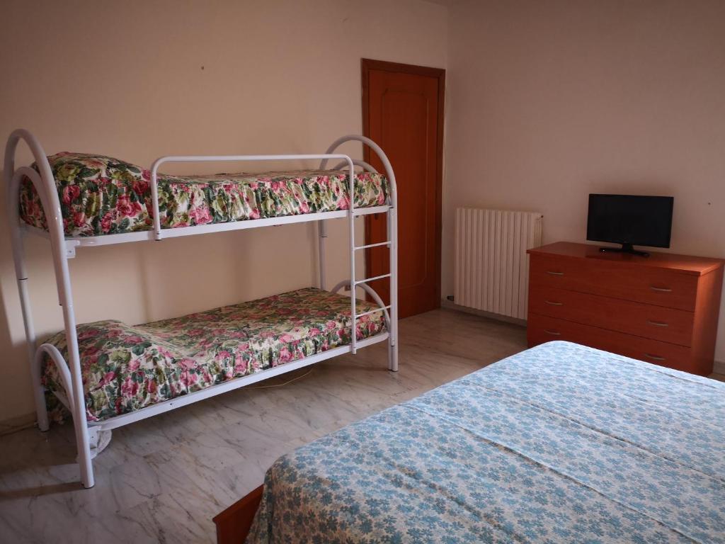 a bedroom with two bunk beds and a dresser at Casa vacanze low cost in Gallipoli