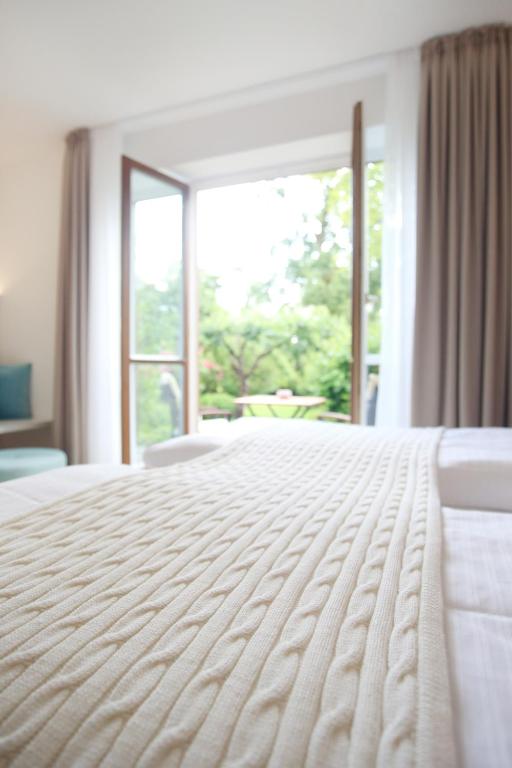 Postel nebo postele na pokoji v ubytování Boutique Hotel Reschen