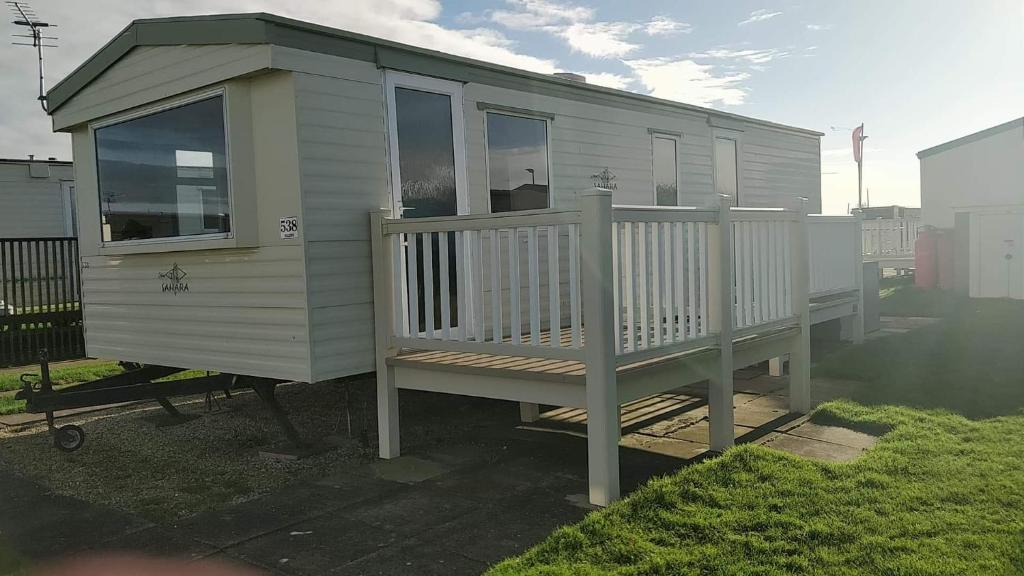 a tiny house sitting on a deck in a yard at 6 Berth Golden Sands Ingoldmells Sahara in Ingoldmells
