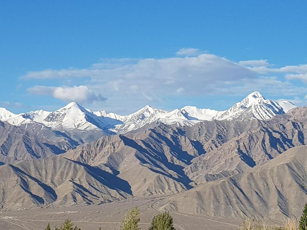 a large mountain range with snow covered mountains at Ladakh Himalayan Retreat in Leh